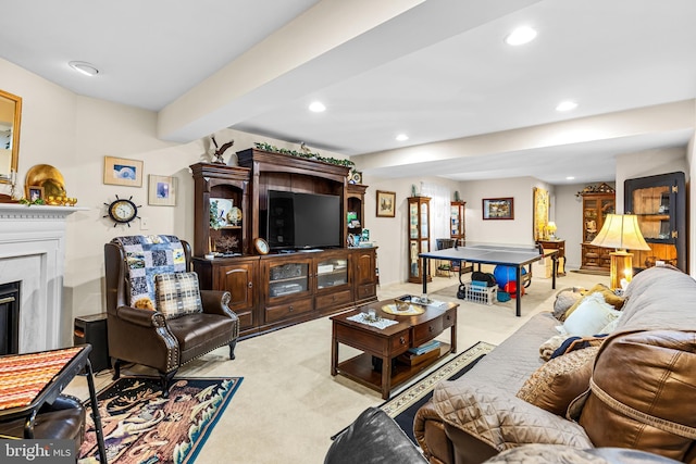 living area featuring carpet flooring, recessed lighting, and a fireplace