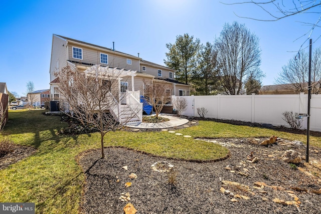 rear view of property with fence, a deck, a lawn, and a pergola