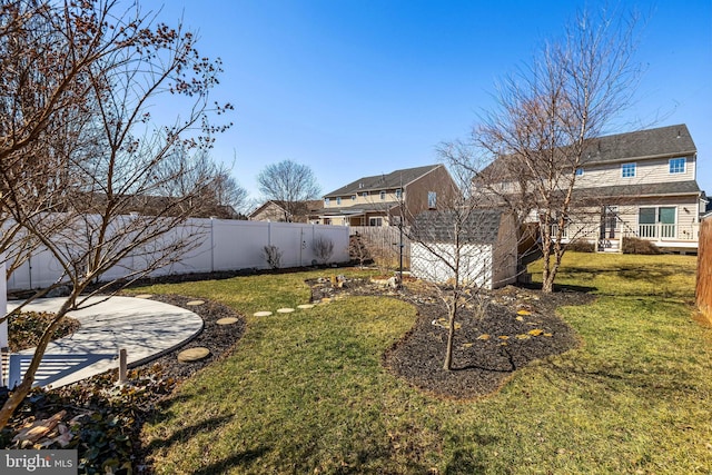 view of yard with a shed, an outdoor structure, and a fenced backyard