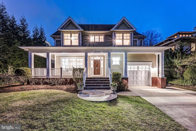 view of front facade featuring a front lawn, a porch, concrete driveway, and a garage