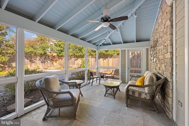 sunroom with vaulted ceiling with beams and a ceiling fan