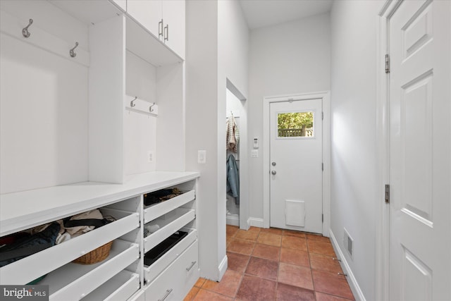 mudroom featuring light tile patterned flooring, visible vents, and baseboards