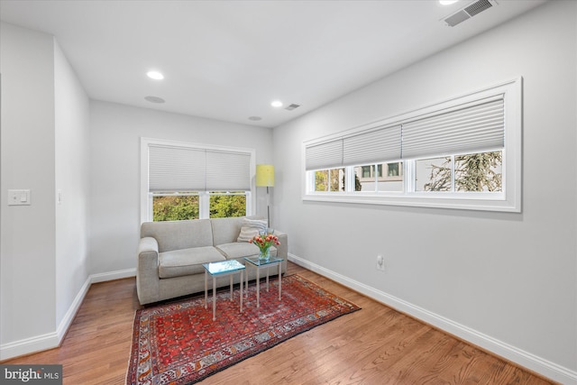 sitting room featuring recessed lighting, wood finished floors, visible vents, and baseboards