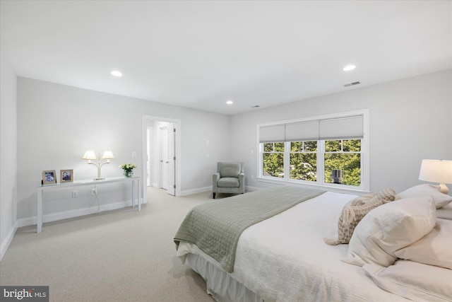 carpeted bedroom featuring recessed lighting, visible vents, and baseboards