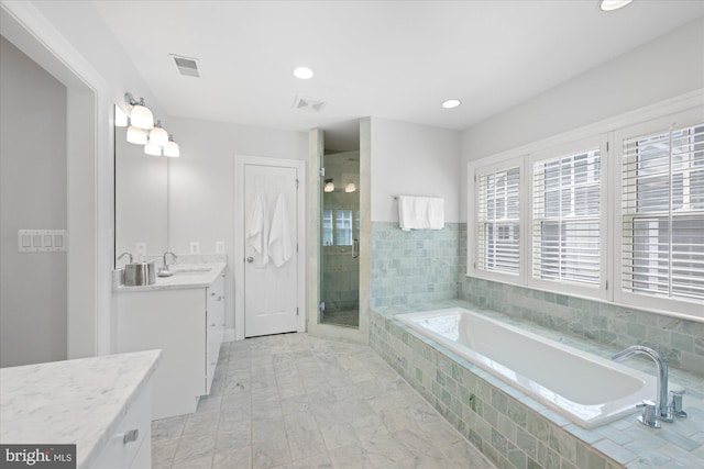 full bath featuring vanity, a shower stall, a bath, and visible vents