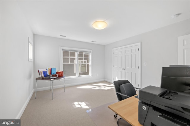 office area with visible vents, a healthy amount of sunlight, baseboards, and carpet floors