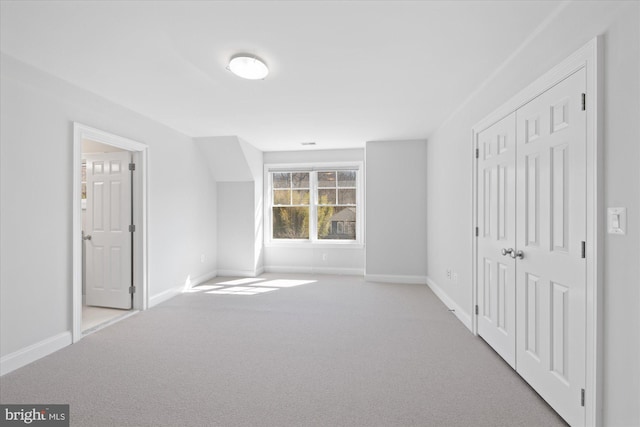 unfurnished bedroom with a closet, visible vents, baseboards, and carpet