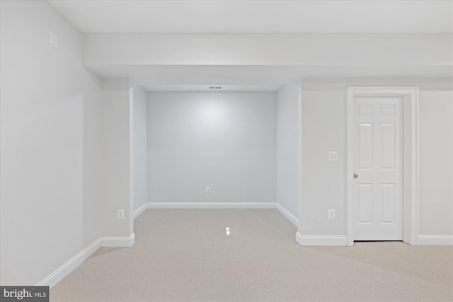 finished basement with baseboards and light colored carpet