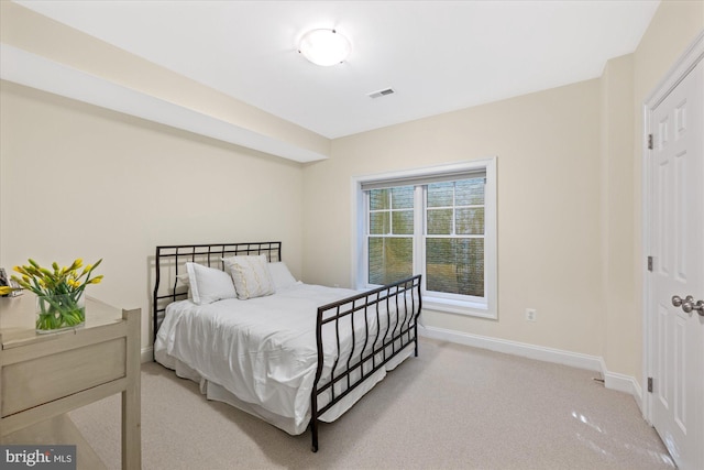 bedroom with visible vents, carpet flooring, and baseboards