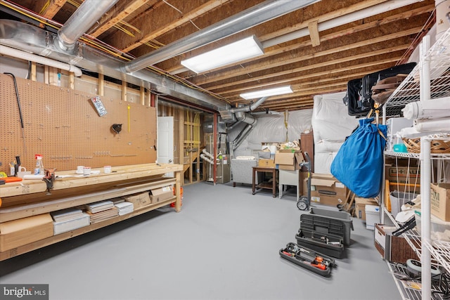 unfinished basement featuring a workshop area