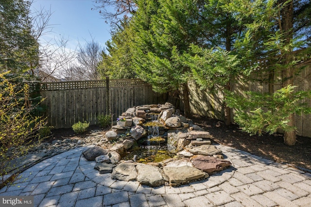 view of yard featuring a patio and a fenced backyard