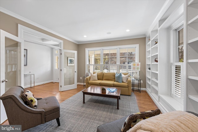 living room featuring french doors, baseboards, light wood-style flooring, and crown molding