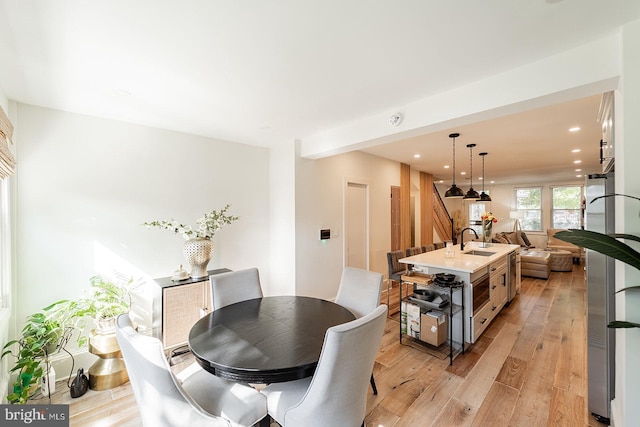 dining area featuring light wood-type flooring and recessed lighting