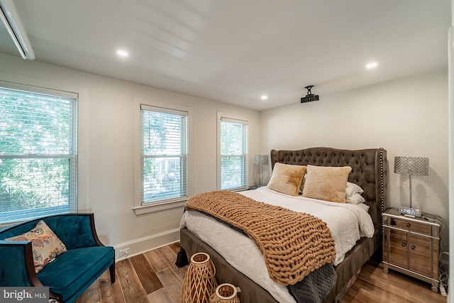 bedroom featuring recessed lighting, wood finished floors, and baseboards