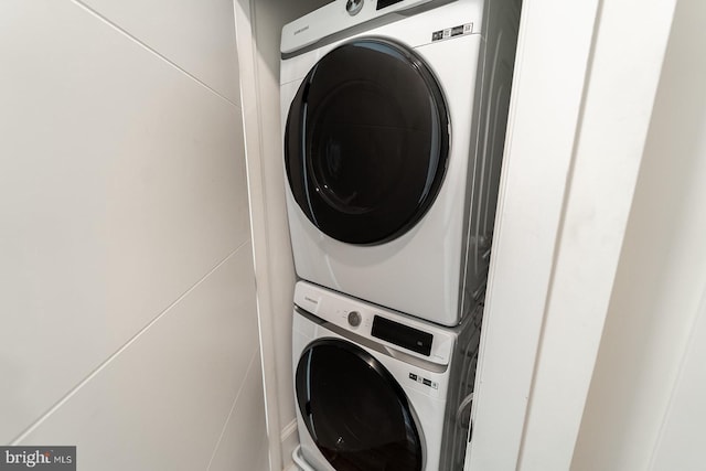 washroom with laundry area and stacked washing maching and dryer