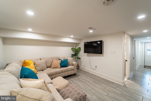 living area with baseboards, recessed lighting, visible vents, and wood tiled floor