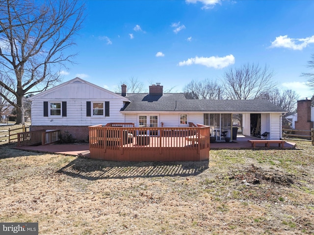 back of property with a patio area, a chimney, fence, and a deck