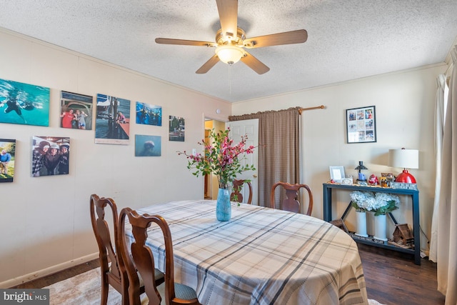 dining space featuring a textured ceiling, wood finished floors, and a ceiling fan