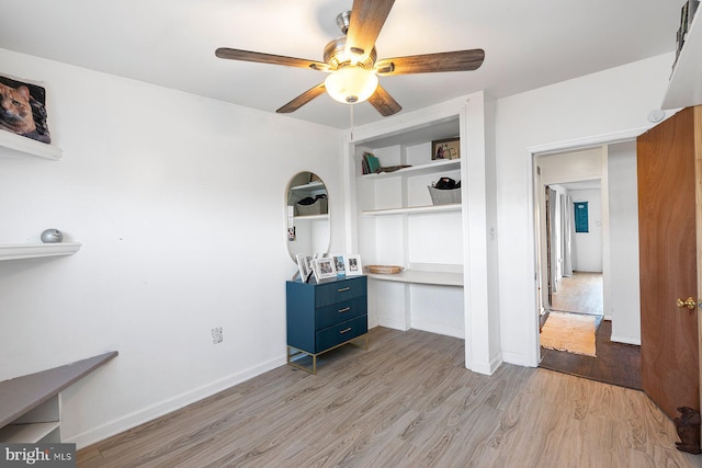 office space with a ceiling fan, baseboards, and light wood finished floors