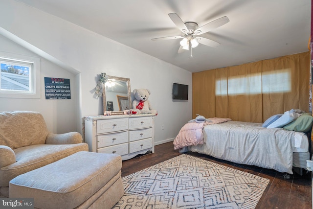 bedroom featuring ceiling fan, baseboards, and wood finished floors