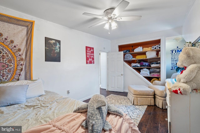 bedroom with dark wood-type flooring, baseboards, and a ceiling fan