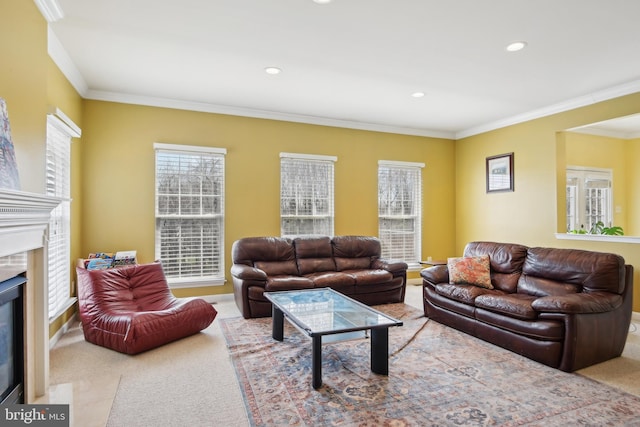 carpeted living room with baseboards, ornamental molding, a glass covered fireplace, and recessed lighting
