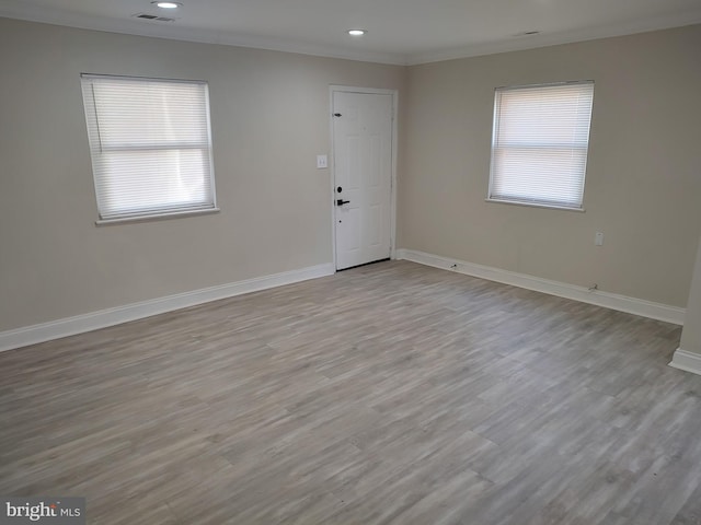 interior space with light wood-style floors, visible vents, plenty of natural light, and baseboards