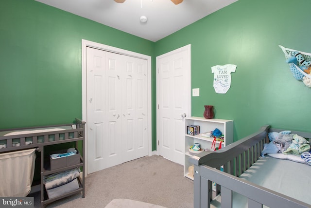 bedroom with a closet, ceiling fan, and carpet floors