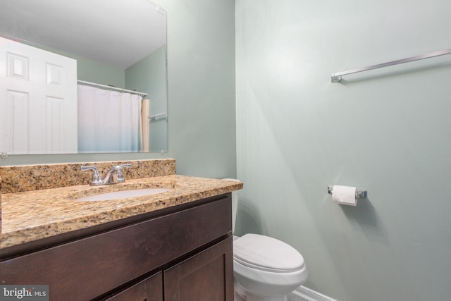 full bathroom featuring toilet and vanity