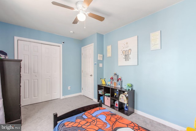 carpeted bedroom featuring baseboards, a closet, and ceiling fan