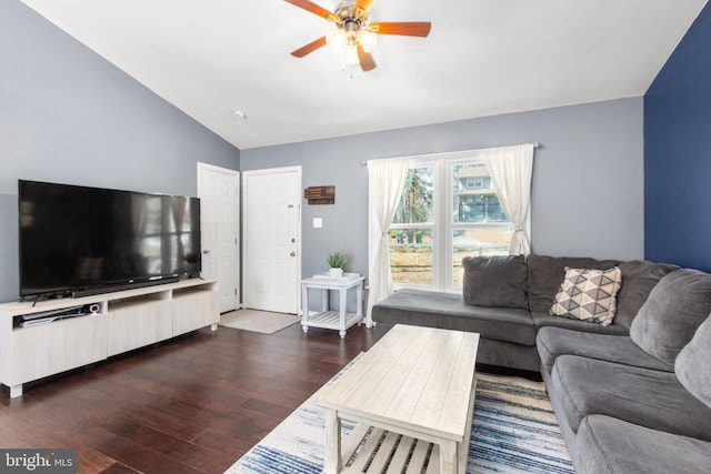 living room featuring dark wood-style floors, a ceiling fan, and vaulted ceiling