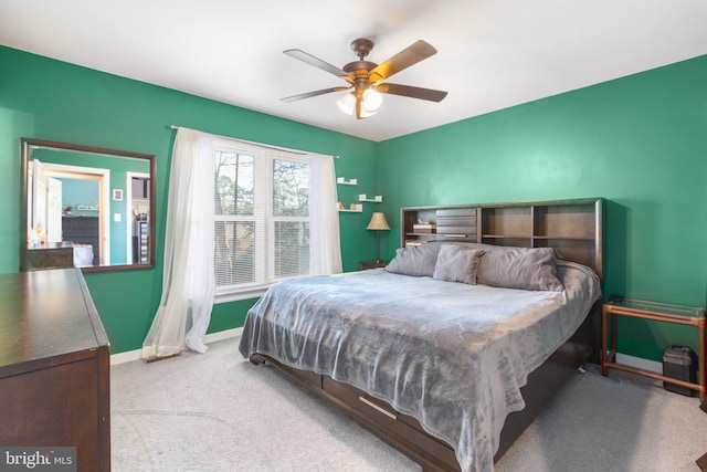 bedroom with ceiling fan, baseboards, and carpet