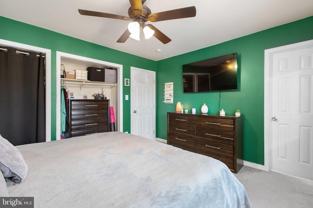 bedroom with a ceiling fan, baseboards, and carpet floors