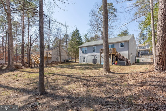 back of house with stairway, central AC unit, a deck, and fence