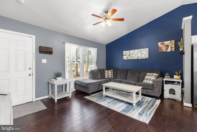 living area featuring baseboards, wood-type flooring, ceiling fan, and vaulted ceiling