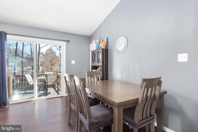 dining space with lofted ceiling and wood finished floors