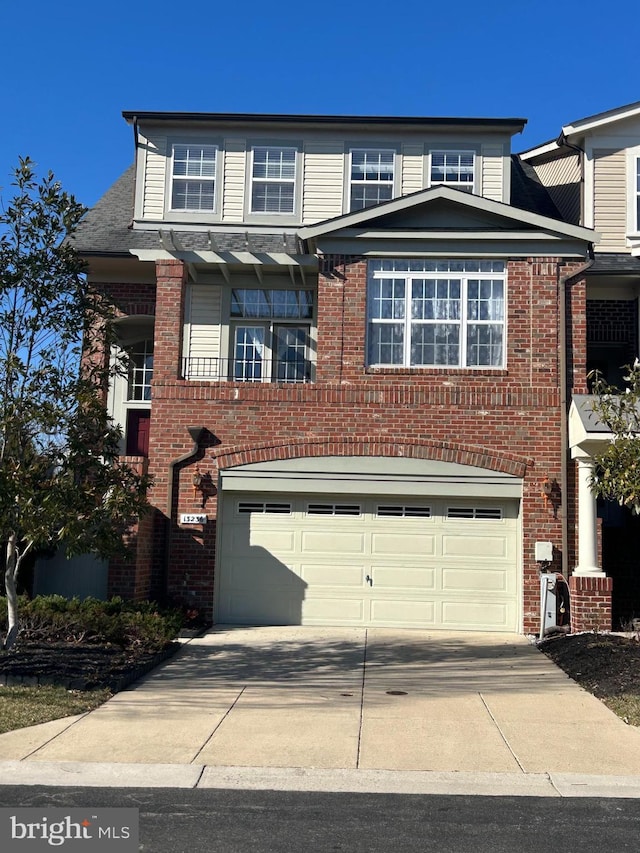 view of front of home featuring a garage, driveway, and brick siding