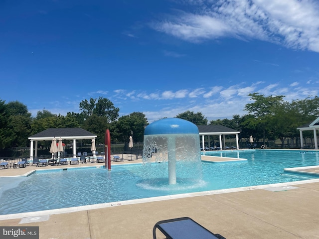 pool with fence, a gazebo, and a patio