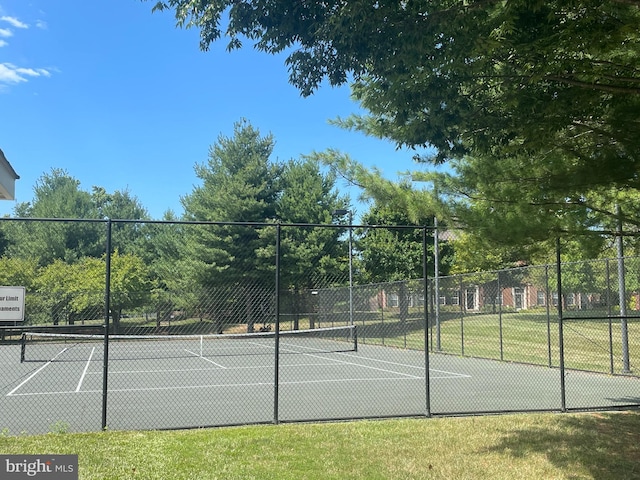 view of tennis court featuring fence