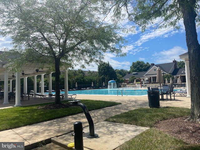 community pool featuring ceiling fan, fence, and a patio