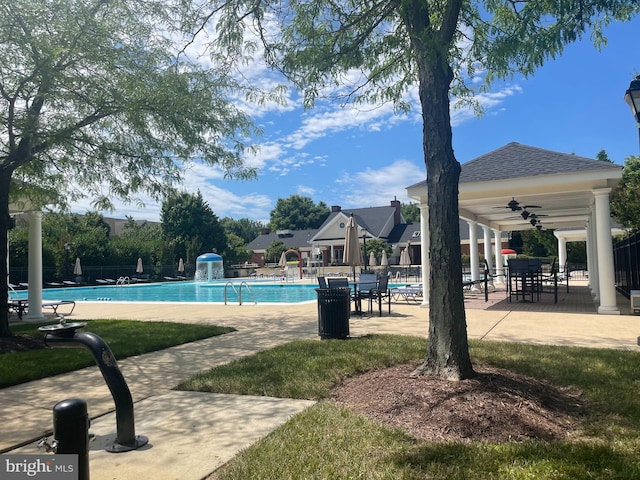 pool with ceiling fan, a patio, and fence