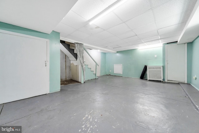 finished below grade area with stairway and a drop ceiling