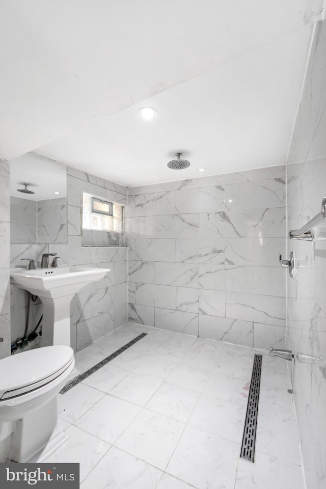 full bath featuring a marble finish shower, marble look tiles, recessed lighting, toilet, and tile walls