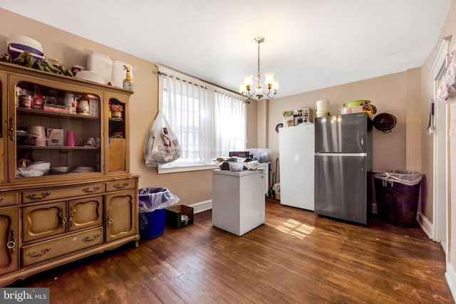 interior space featuring a chandelier, refrigerator, freestanding refrigerator, and dark wood-style flooring