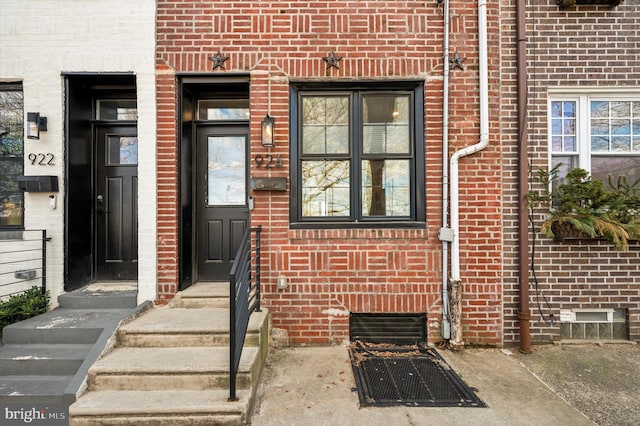 property entrance with crawl space and brick siding