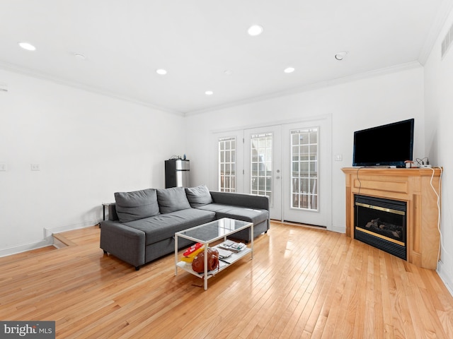 living area with recessed lighting, french doors, crown molding, and hardwood / wood-style flooring