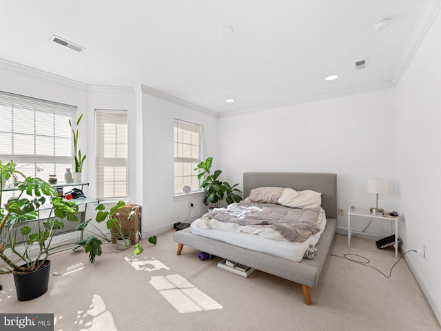 bedroom with carpet flooring, multiple windows, visible vents, and ornamental molding