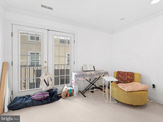 sitting room featuring carpet, visible vents, and ornamental molding