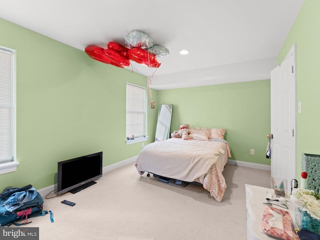 carpeted bedroom with multiple windows, recessed lighting, and baseboards