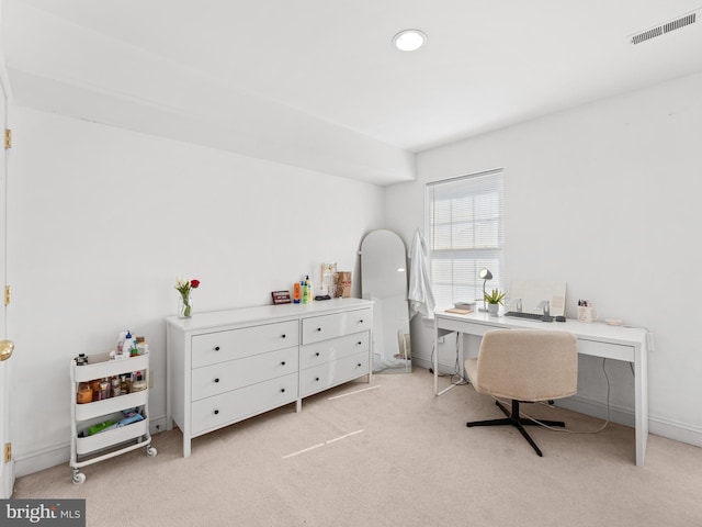 home office featuring light carpet, visible vents, and baseboards